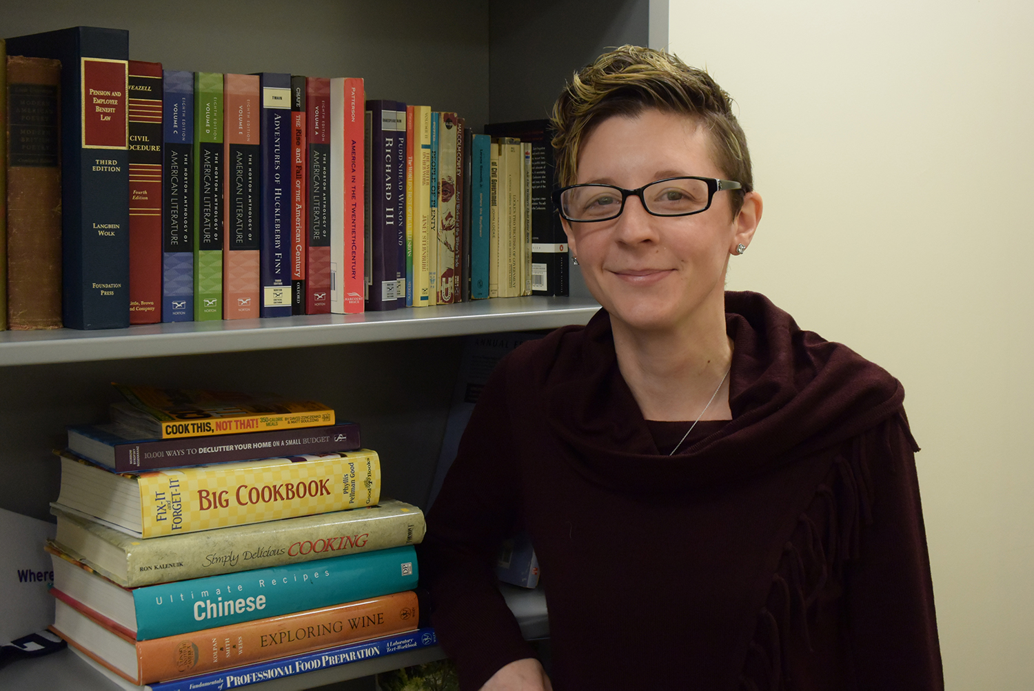 An OCC student next to books