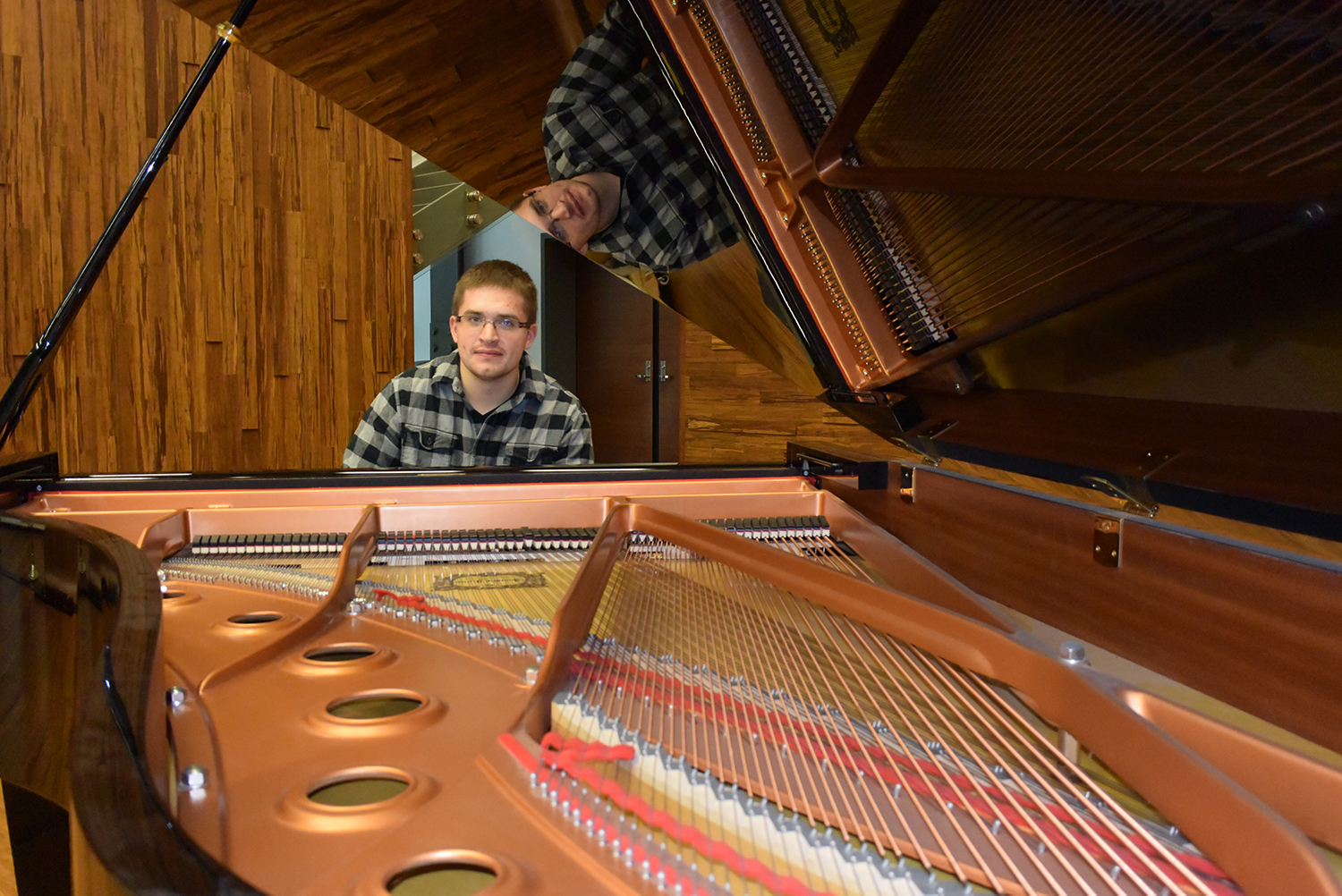 A student sitting at a piano