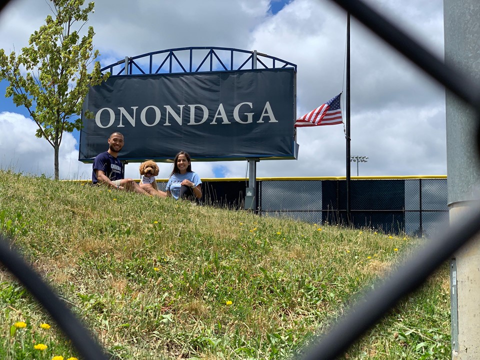 Justin and Jess with their dog and an Onondaga Sign in the background 
