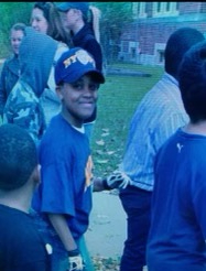 Tigner Jr., pictured as a youth, wearing an NYPD cap.