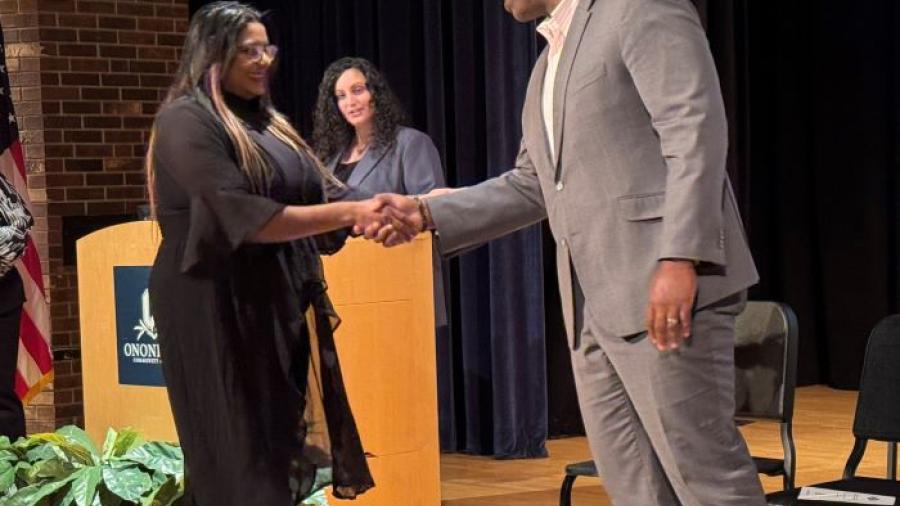 Mirianny Tifa Paulino (left) is welcomed into the Phi Theta Kappa Honor Society by OCC President Dr. Warren Hilton (right).