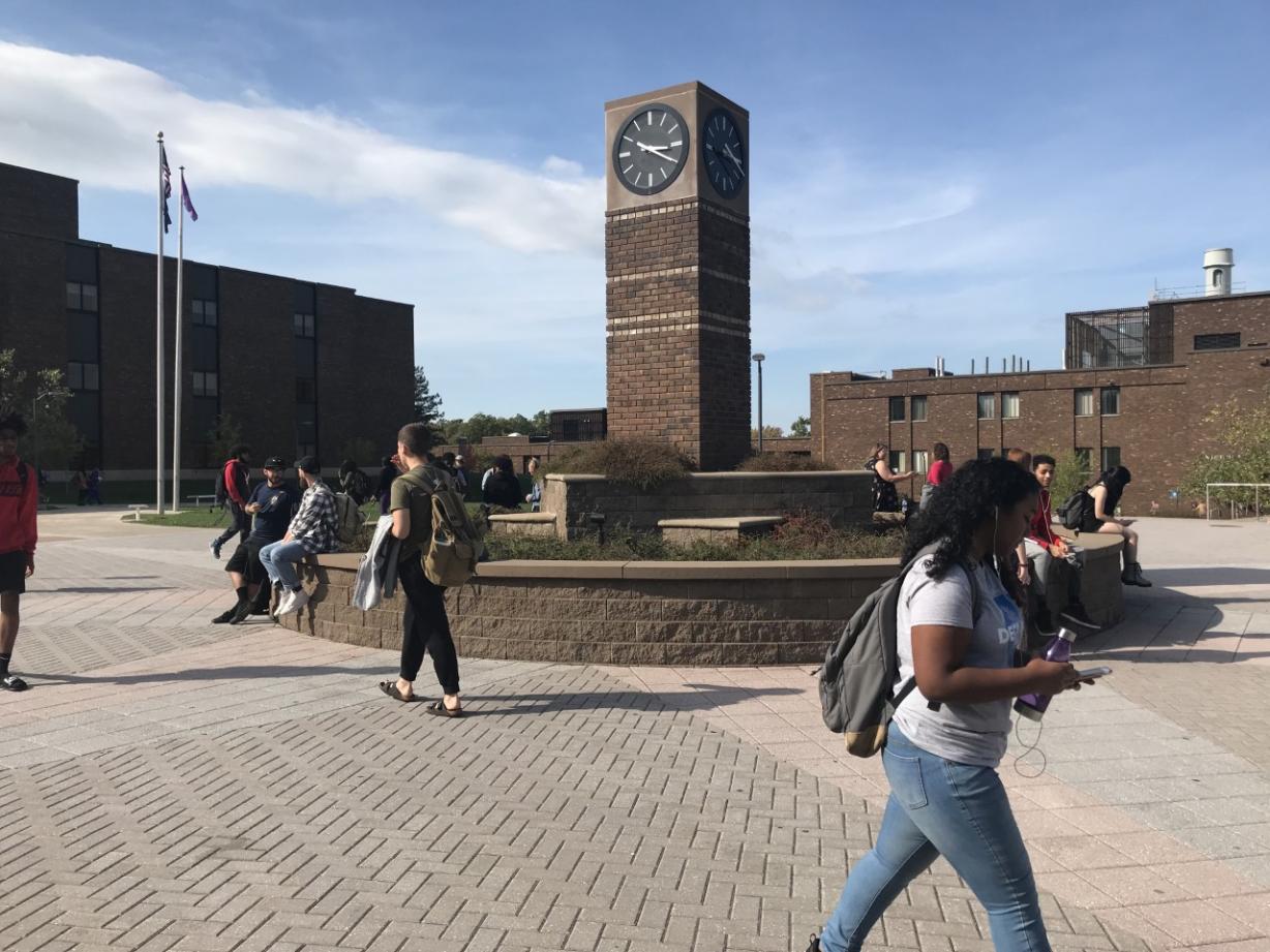 Clock Tower on OCC Campus with Students Walking Around