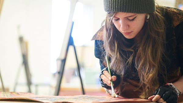 A student painting at OCC