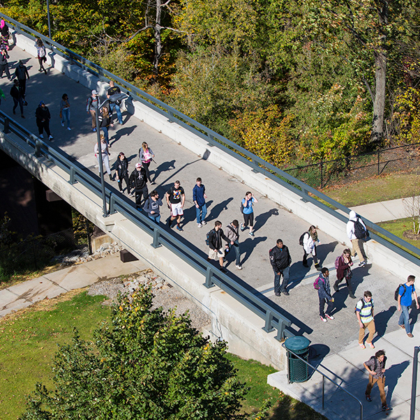 Students walking across the bridge