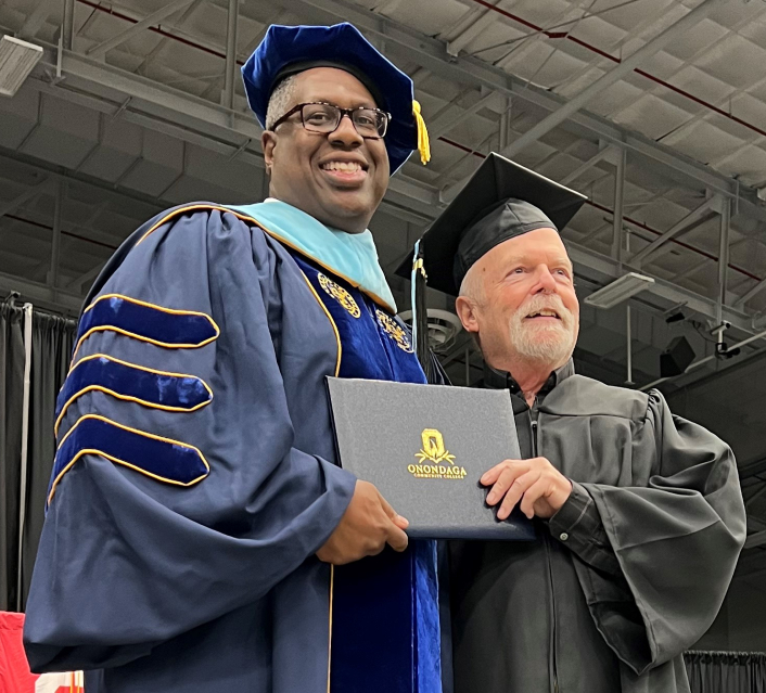President Dr. Warren Hilton (left) presented Dave Cook (right) with his degree. Cook had left OCC 50 years earlier one class shy of completing his degree.