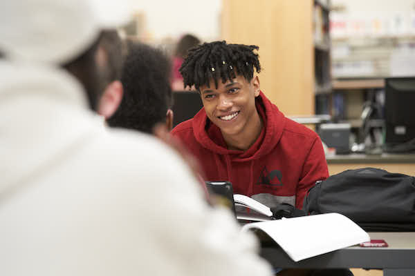 Student talking with friends in a Library