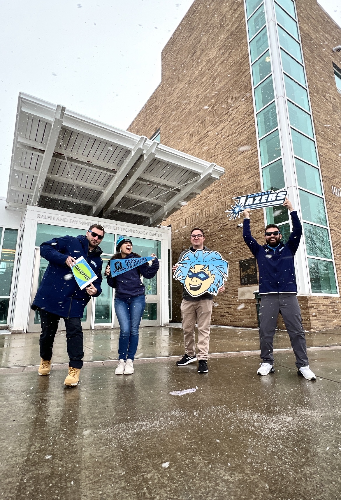 Our admissions team posing with fun OCC objects in front of Whitney