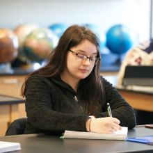 Student taking notes in class