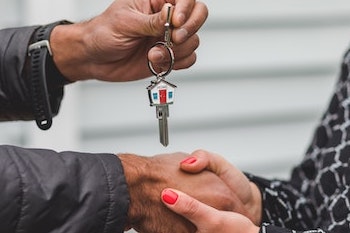 Realtor handing home keys to new homeowner