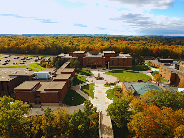 Aerial view of Onondaga Community College campus surrounded by autumn trees.