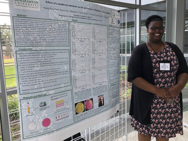 OCC student Sherly Jean-Paul shows off the product of her research at SUNY Binghamton.