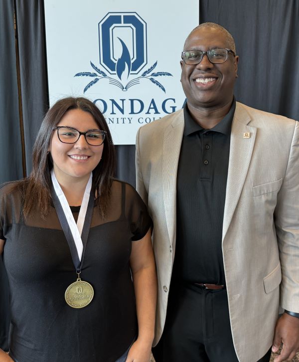 Melissa Durand (left) is presented a Trustee Award by OCC President Dr. Warren Hilton (right).