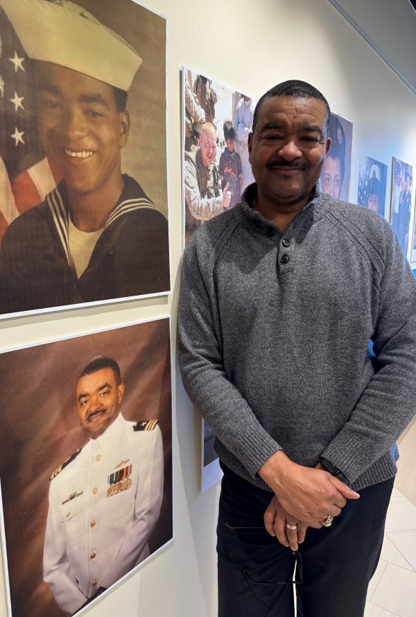 Reg Braggs stands next to two photos of himself. He retired from the Navy after 24 years of service. Braggs is OCC's Director of Central New York Partnerships.