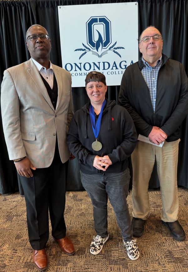 Pinnacle Award recipient Jamie Biviano (center) is pictured with her Presenter Steve White (right) and OCC President Dr. Warren Hilton (left).