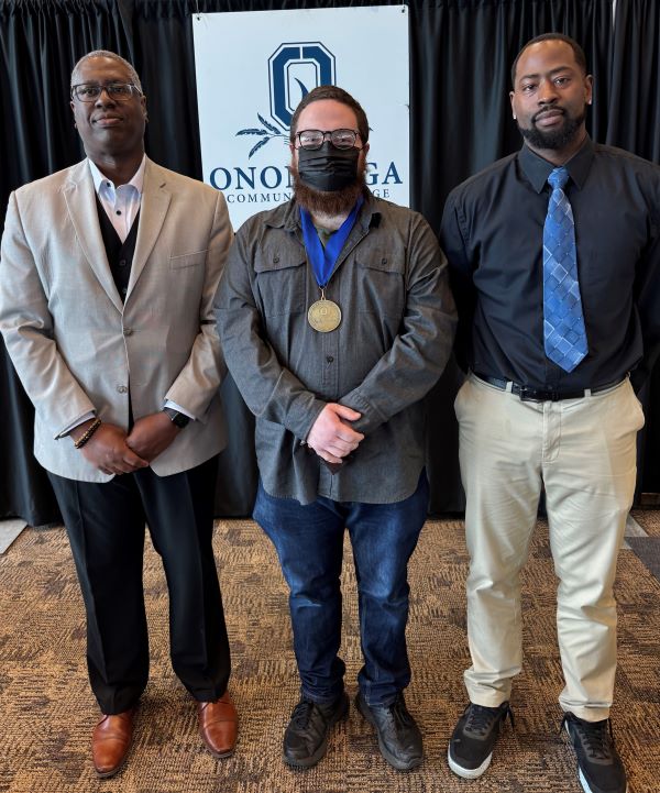 The Pinnacle Award for TRIO is Pine Boyer (center). Also pictured are presenter Chris Gilkes (right) and OCC President Dr. Warren Hilton (left).
