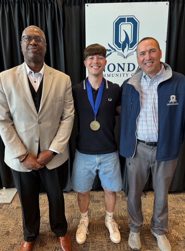 The Pinnacle Award recipient for International Students is Oliver Greer (center). Also pictured are presenter Mike Borsz (right) and Dr. Warren Hilton (left).