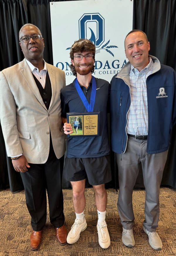 The Pinnacle Award recipient for Athletics is Paul Clark (center). Also pictured are presenter Mike Borsz (right) and OCC President Dr. Warren Hilton (left). Clark was also presented with the SUNY NJCAA Scholar Athlete of the Year award for Men's Cross Country.