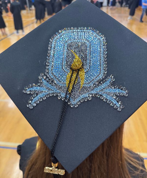 Graduating Art major Madison McKeon (Westhill High School) decorated her mortar board with the OCC logo.