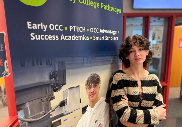 Student standing in front of an Early College Pathways banner.