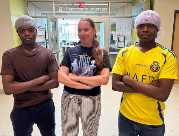 Educational Opportunity Program Interim Director Shannon Nolan (center) is pictured with twin brothers Huseni (left) and Hasani (right) Musa outside OCC's Opportunity Programs office on the second floor of Coulter Hall.
