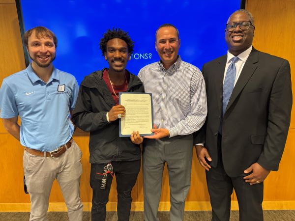 Triple Jump National Champion Ny'Quez Madison received his ring and a resolution passed in his honor. Pictured (left to right) are Track & Field Head Coach Taylor Bouchard, Ny'Quez Madison, Director of Athletics Mike Borsz, and OCC President Warren Hilton.