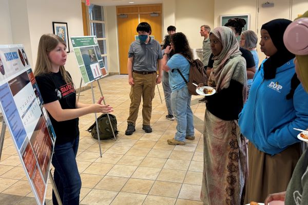 Alicia Oberlender (on the left in black t-shirt) spoke with students about her internship experience with NASA.