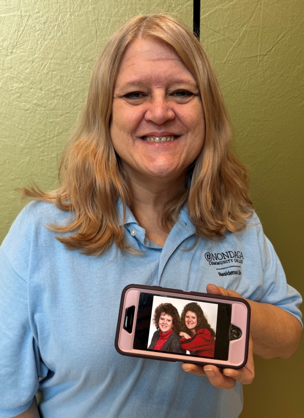 Dana Marzynski holds up a picture of herself with her twin sister Dale.