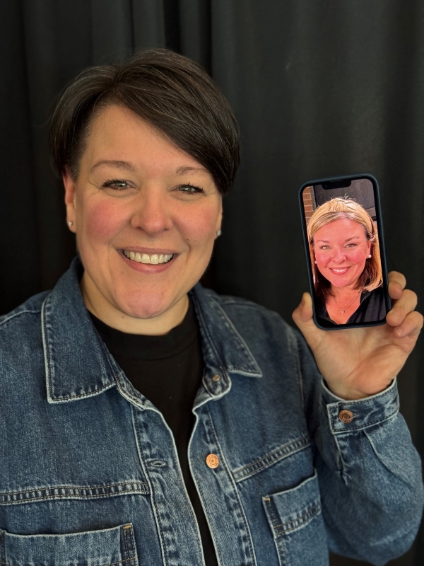 Professor Dr. Annie Tuttle holds up a picture of her twin sister Ali.