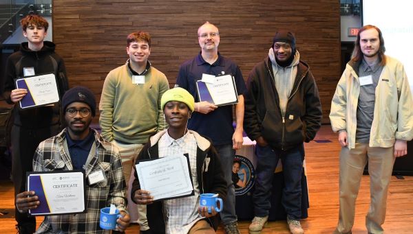 Graduates of the Advance 2 Apprenticeship program pose for a group photo at their graduation ceremony on the Onondaga Community College campus.
