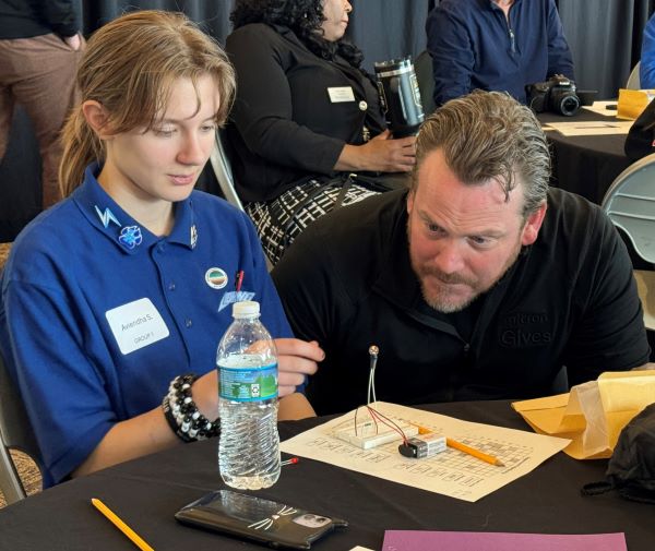 Micron Fellow Brian Heffron (right) of the MOST and Citi BOCES worked with students during the "Battleship and Breadboarding" workshop in the Gordon Student Center Great Room.