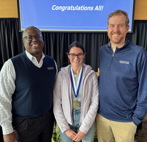 Vanessa Esposito (center) received the Pinnacle Award from OCC President Dr. Warren Hilton (left) and Director of International Student Services Ryan Nellenback (right).