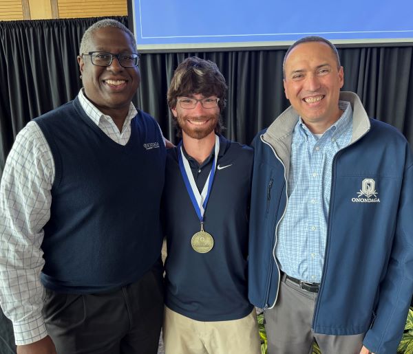 Paul Clark (center) won the Pinnacle Award for Athletics. He's pictured with President Dr. Warren Hilton (left) and Director of Athletics Mike Borsz (right).