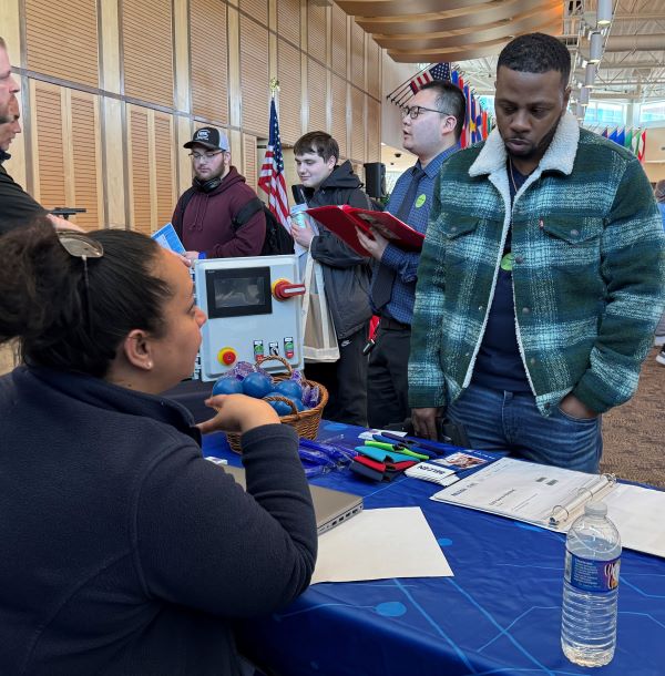 Bruce Christian (right), who completed his Electromechanical Technology degree last December, returned to campus to speak with employers at the STEM Career Showcase.