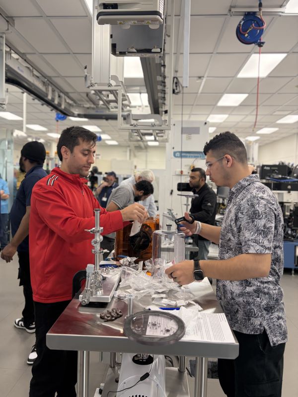 Sayed Ehsanullah Ahmady (left) and M. Ferooz Bashardost (right) collaborate on a vacuum system project in the Micron Cleanroom Simulation Lab on the Onondaga Community College campus.