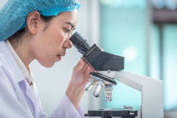 Scientist looking through a microscope