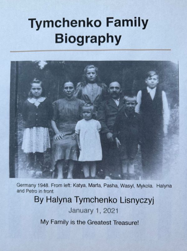 Their next book will tell the story of Halyna's family. In the family photo, she is standing in front wearing a white dress.
