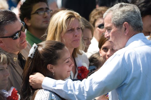 Holder took this photo of President George W. Bush consoling family members at a Fallen Law Enforcement Officers ceremony.