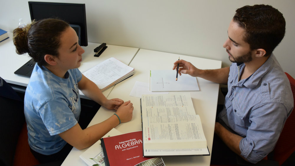 Student-tutor Corrine LaFrance (left) tutors Nick Simmons (right) in calculus.