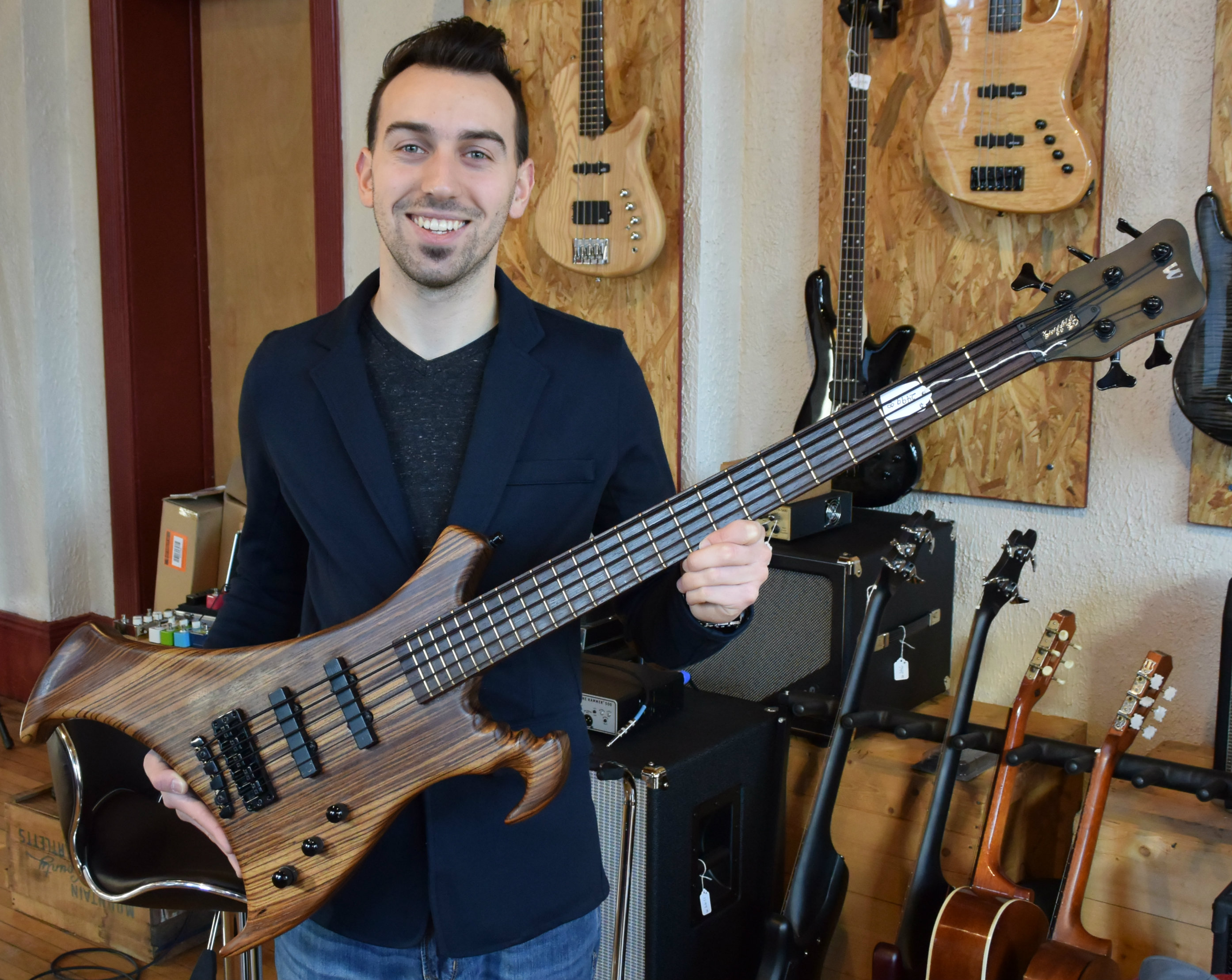 Wilson is holding a &quot;Warrick Buzzard&quot; bass guitar designed by legendary Who bass player John Entwistle. It's one of only a handful in existence. Wilson bought it when he was 15, sold it, then bought it again before his store opened.