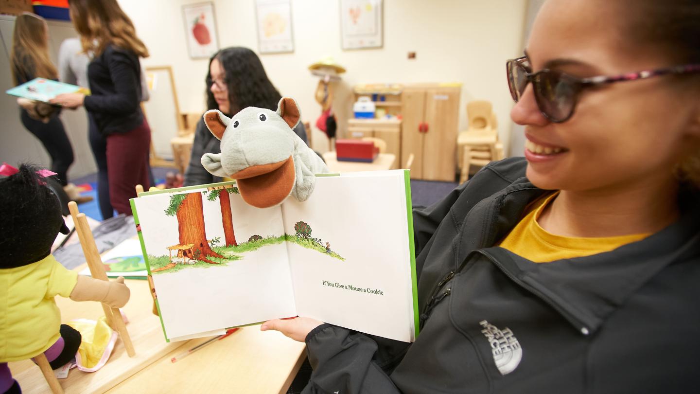 Woman reading a book to a child