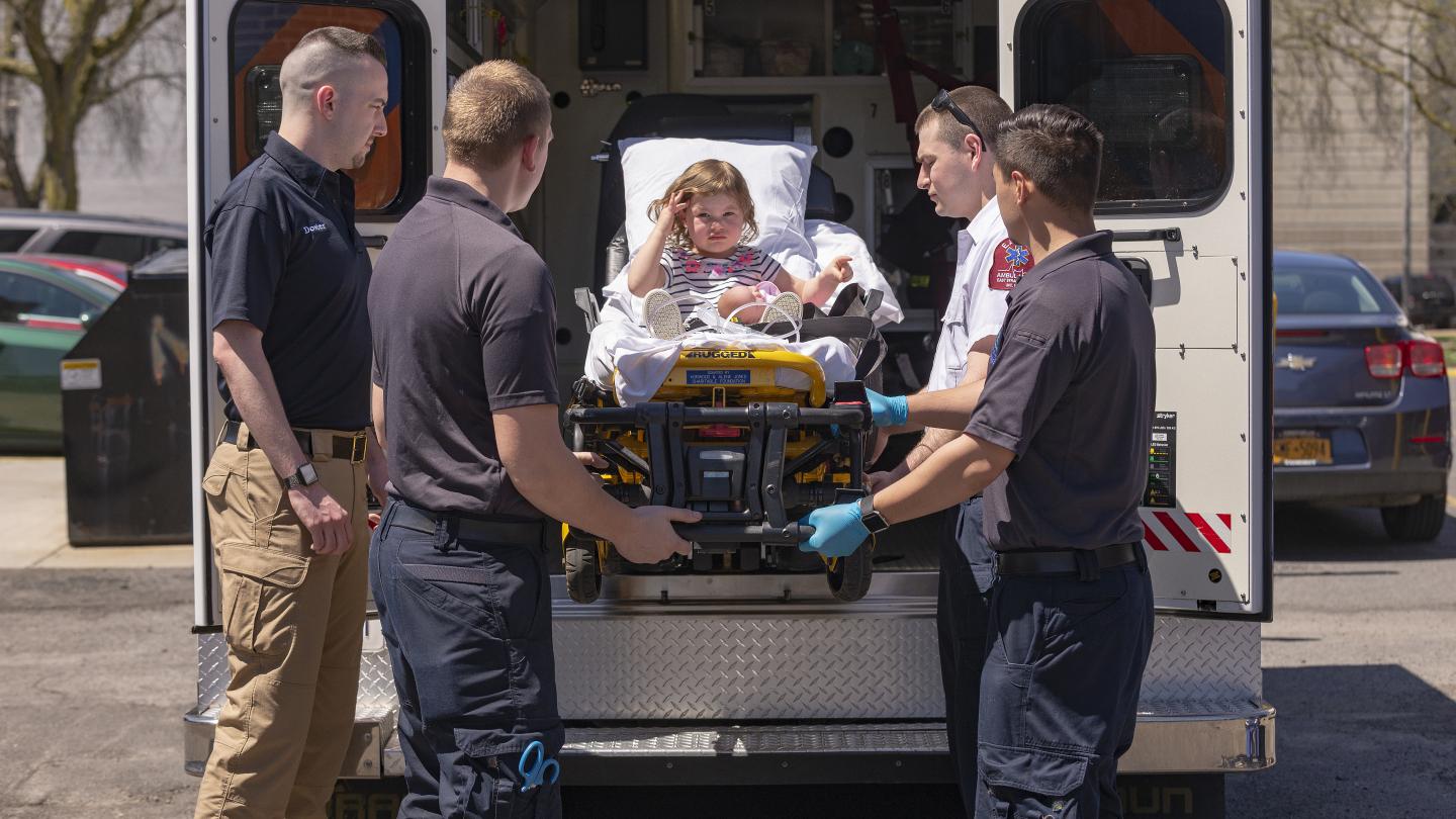 Paramedics caring for a child patient