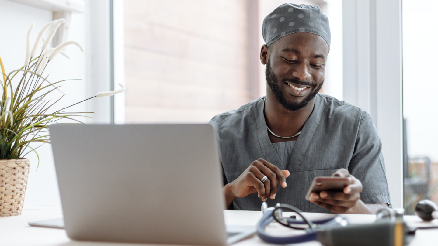Nurse reading phone and computer