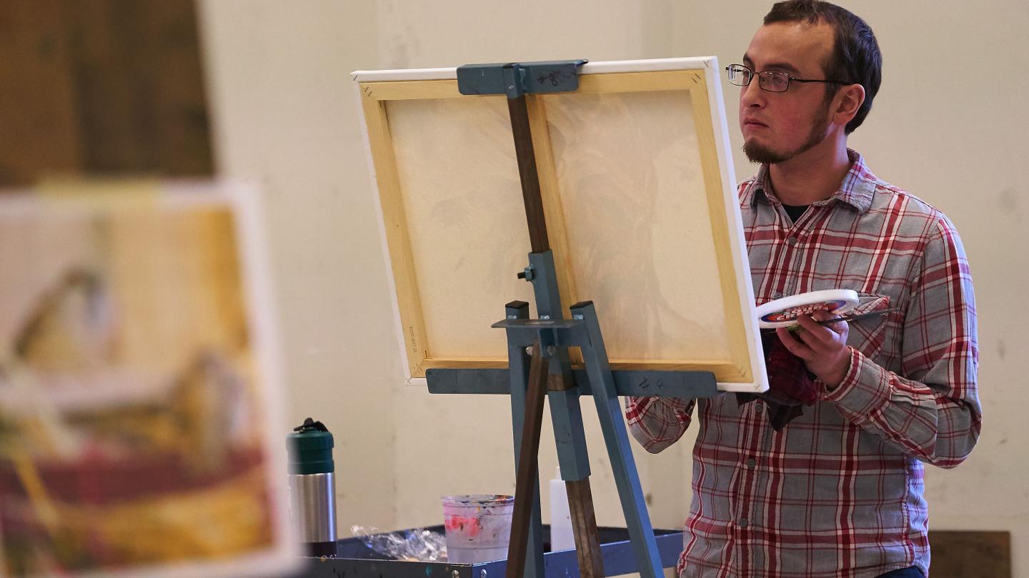 Student painting in class