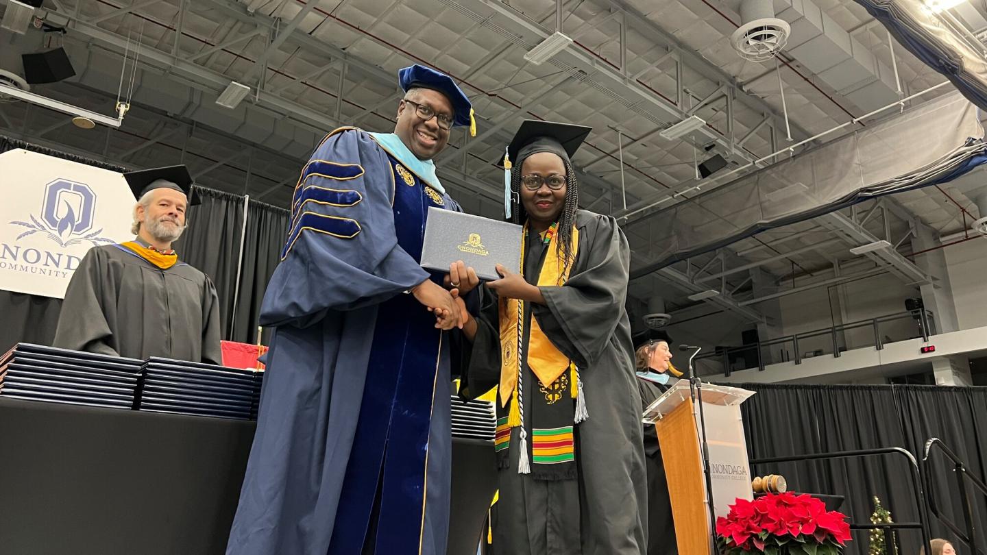 DSC_9851.JPG student receiving a diploma from Dr. Hilton