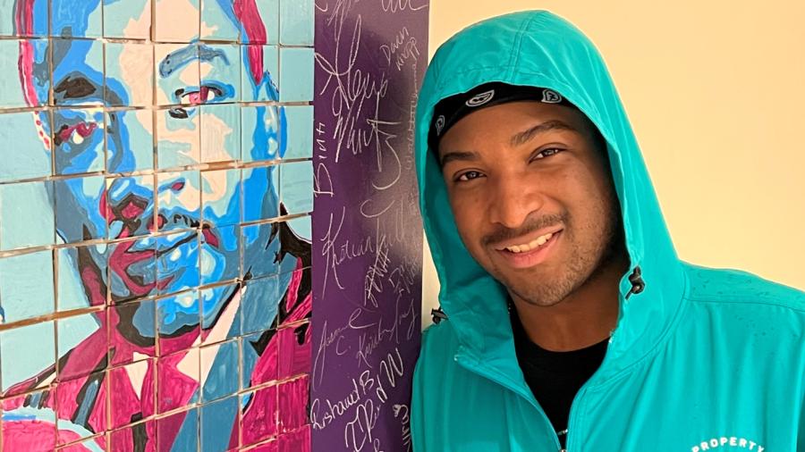Joshua Newman will complete his General Studies degree this month. He's pictured next to a mosaic of Dr. Martin Luther King, Jr. which was made during Unity Day. Newman was on the Unity Day Advisory Board.