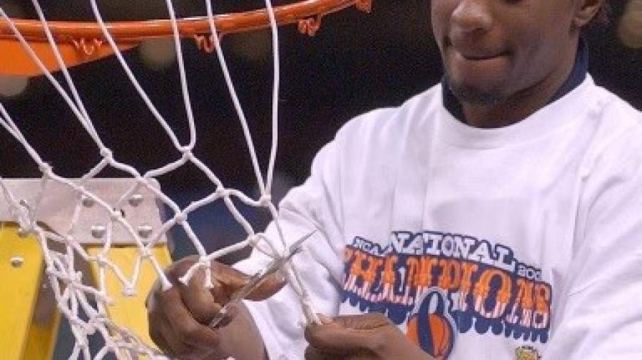 Tyrone Albright '02 cuts down the net following Syracuse University's victory in the 2003 NCAA National Championship Game. (photo courtesy Tyrone Albright)