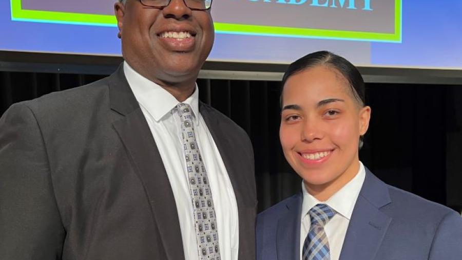 OCC President Dr. Warren Hilton (left) congratulated Nadia Diaz '20 (right) on becoming a new Syracuse Police Officer. She was sworn-in during a ceremony in Storer Auditorium.