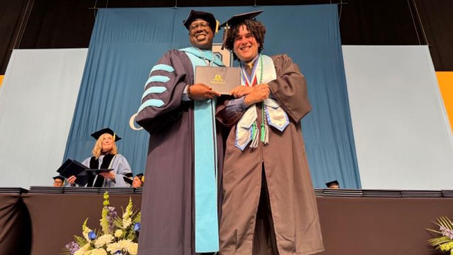 Yesvier Aviles Mendez (right) receives his Physical Therapist Assistant degree from OCC President Dr. Warren Hilton (left).