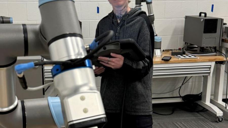 Dio Brown is a 35-year-old OCC student who is about to complete the Electromechanical Technology degree program, then pursue a bachelor's degree tuition-free. Dio is pictured in the robotics lab in the Whitney Applied Technology Center.