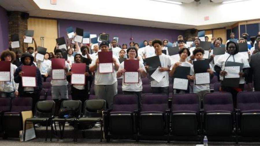 Syracuse City School District students show off their certificates during a P-TECH signing ceremony in OCC's Storer Auditorium.
